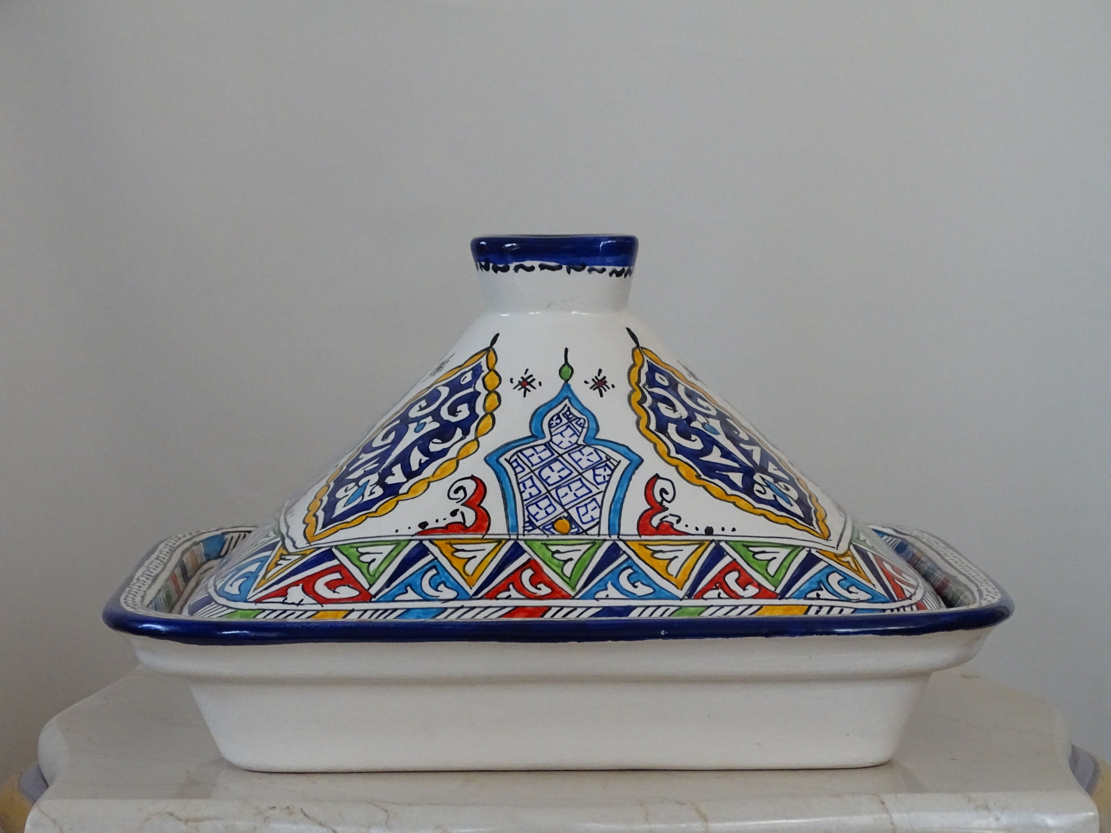 Moroccan Pottery's Large high clay made Tajine, designed for serving tasty meals.  this pot includes a lid, perfect for keeping dishes warm